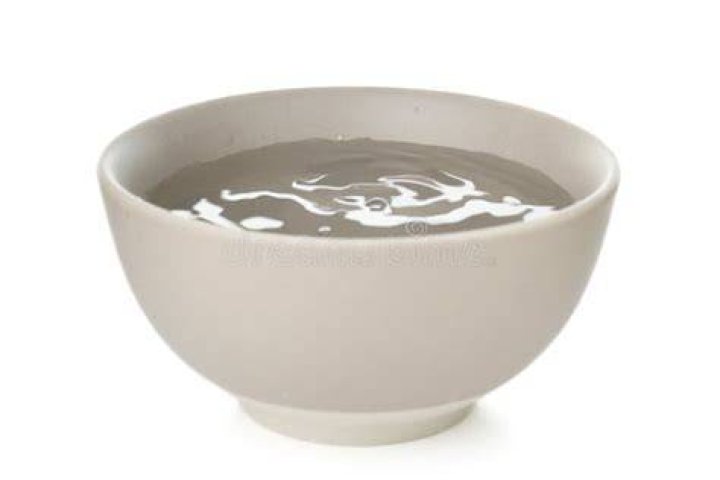 A bowl full of white and dark chocolate covered pretzels.