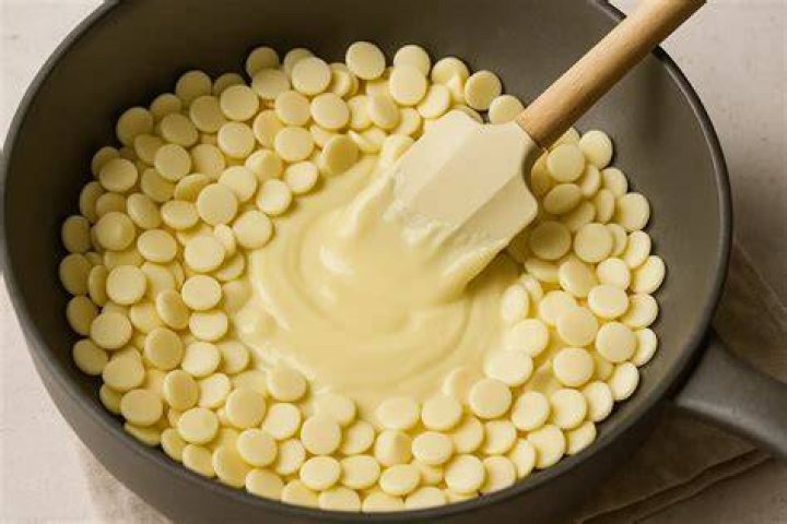Melting white chocolate chips and dipping pretzels.